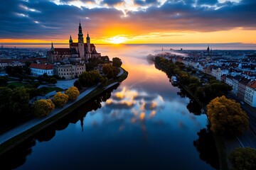 A sunrise over Wawel Castle, with the morning mist rising from the Vistula River