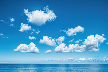 Obraz premium White clouds in deep blue sky above ocean horizon