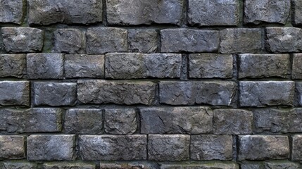 Naklejka premium Textured gray stone wall with a rough finish in an outdoor setting during daylight