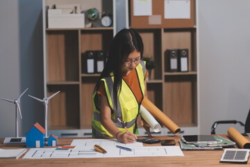 Female architect working at home She looked at the blueprint.