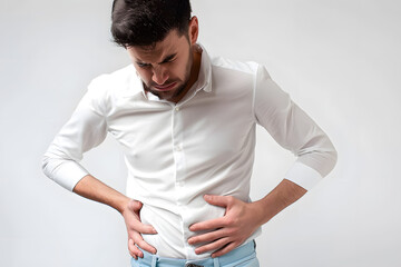 A man in a white shirt is clutching his stomach with a pained expression on his face. He appears distressed, isolated against a plain white background