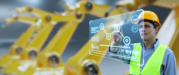 Engineer monitoring robotic AI arms in manufacturing factory plant, manager managing controlling using computer holographic ui display analysis innovation technology, male engineer, banner background.