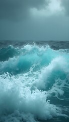 Turquoise ocean water sea foam on a stormy day with dark clouds and rough waves wallpaper background