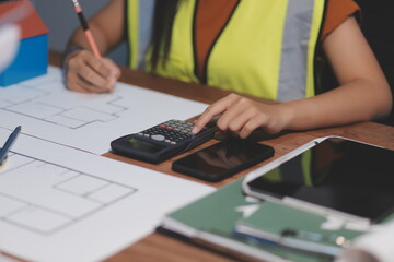 Female architect working at home She looked at the blueprint.