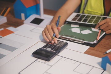 Female architect working at home She looked at the blueprint.