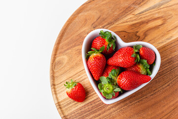 Fresh strawberries in heart bowl