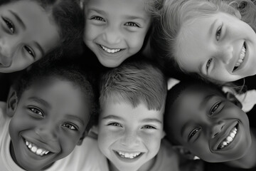 Obraz premium Black and white portrait of a diverse group of smiling children with their heads together, representing unity, friendship, and joy, celebrating World Children's Day on November 20