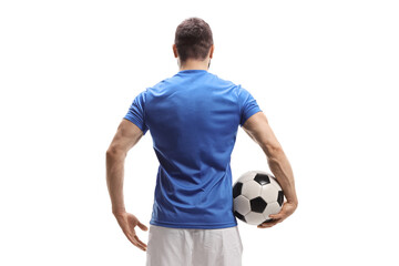 Rear view shot of a soccer player with a ball under arm