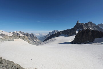The Punta Helbronner glacier at 3,466 m on the Mont Blanc massif with climbers roped on the glacier. Aosta Valley, Italy.
