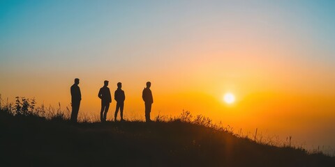 Silhouetted figures stand against a vibrant sunset, capturing a moment of reflection and tranquility in nature's embrace.