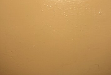 Old wall painted with orange oil paint.