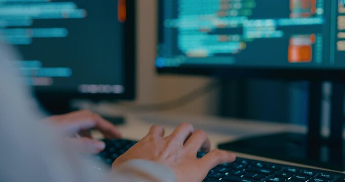 Closeup young adult Asia female freelance typing write prompt AI bot IT app program nomad, video game, terminal with coding language, designer, big data center on desktop computer in night office.