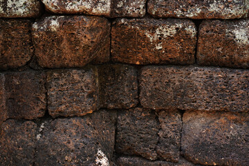 Ancient laterite brick wall for abstract seamless background and texture. beautiful patterns, space for work, close up.