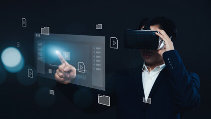 Businessman using VR virtual reality headset gear, working with multimedia software application technology, tools for business production, managing computer files document in augmented reality.