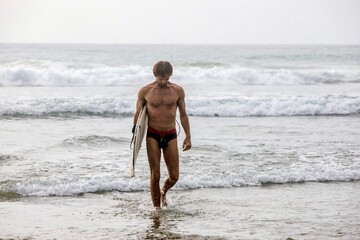 Fototapeta premium man walking on the beach