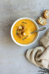 Creamy pumpkin soup served in a bowl for a cold day. Copy space.