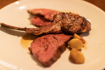 Succulent roasted meat dish served with caramelized garlic.