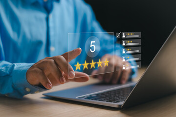 Businessman using finger tap star icon to give highest rating of five on virtual notebook screen,...