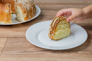 Cropped hand of person holding sweet Muscocho cake in plate on table