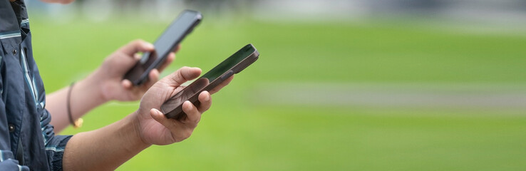 Man using smartphone in outdoors.