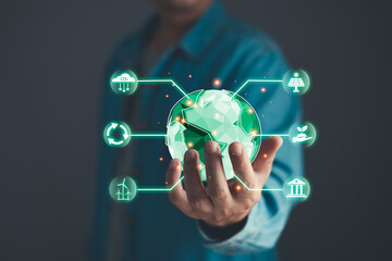  Sustainable Development and Green Business Innovation concept.climate change,hand hold hologram to save energy,and reduce global warming,ecology friendly investment,ESG environment social governance.
