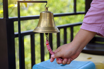 The handle of the rope rings a brass bell to tell the bus operating time. soft and selective focus.