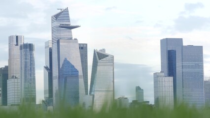 New York City waterfront skyline, Manhattan Midtown Hudson Yards buildings, riverfront skyscrapers. Waterside cityscape from Pier A Park, Hoboken, New Jersey. United States architecture, grass lawn.