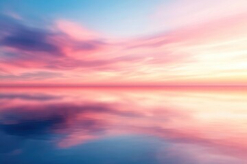 Obraz premium A serene sunset over a calm ocean, blending soft pinks and blues. A perfect scene for relaxation and inspiration.