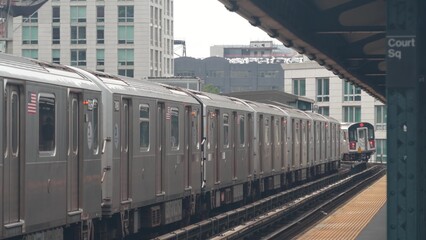 Obraz premium New York subway station. Metro train on metropolitan platform, United States public transportation. Elevated outdoor Court Square railway line, Queens. NYC passenger railroad traffic, Long Island City
