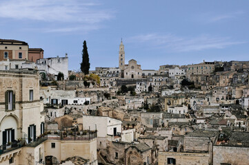 Obraz premium Panoramic view of Matera (Italy) famous throughout the world for its Sassi, ancient neighborhoods dug into the limestone rock, unique examples of rock architecture. UNESCO heritage