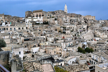 Obraz premium Panoramic view of Matera (Italy) famous throughout the world for its Sassi, ancient neighborhoods dug into the limestone rock, unique examples of rock architecture. UNESCO heritage