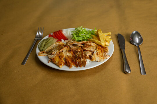 Chicken d&ouml;ner on rice in a white plate