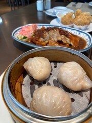 Steamed Shrimp Dumplings with Roast Duck and Crispy Dim Sum in Traditional Chinese Restaurant