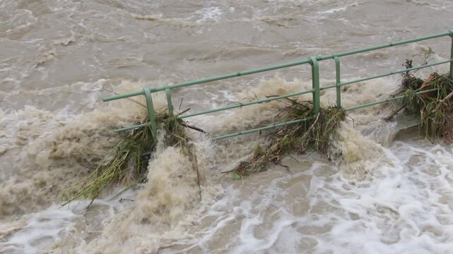 River overflows in floods, pedestrian stiles flooded with water.