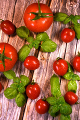 ingredients for making ketchup. ketchup in a white bowl on the table with tomatoes and basil.