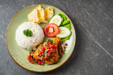 Nasi Ayam Geprek is Indonesian Food crispy fried chicken with hot and spicy sambal bawang. Served with rice
