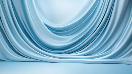 A blue curtain hangs in front of a white wall. The curtain is long and flowing, creating a sense of movement and elegance. The blue color of the curtain adds a touch of sophistication