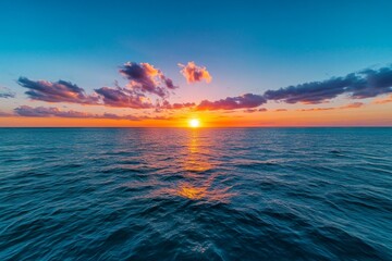 Obraz premium Calming coral sunset over the horizon, blending soft hues of pink and orange into the sky