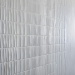 close-up view of a textured surface with a repetitive pattern. The surface is white and features horizontal rows of small, evenly spaced vertical ridges.