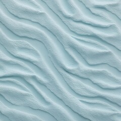 Fototapeta premium Close-up view of a textured surface with a consistent pattern. The surface appears to be a light blue color, with a slightly rough and uneven texture that resembles ripples or waves.