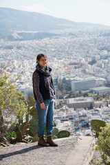 Naklejka premium Beautiful female model on Lycabettus with a stunning view of Athens