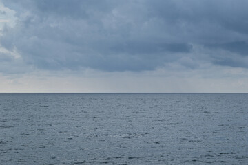 Seascape with stormy clouds over the sea. Nature composition.