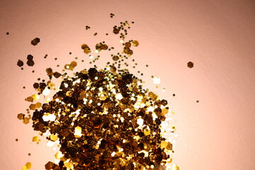 golden shiny glitter on a light brown background