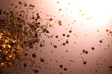 golden shiny glitter on a light brown background