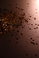 golden shiny glitter on a light brown background
