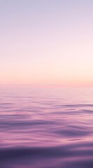 Tranquil sunset over a calm ocean with soft pastel colors reflecting on the water, creating a peaceful and serene seascape.