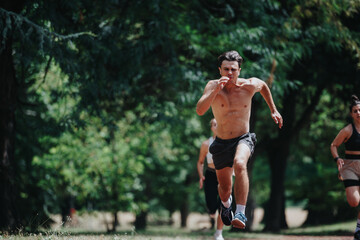 Group of athletes sprinting in a park, focusing on outdoor fitness, teamwork, and a healthy lifestyle.