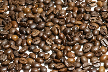 Background from roasted black coffee beans on a white background