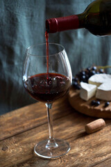 Red wine is poured into a glass