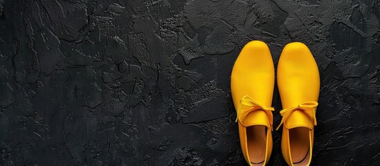 Yellow flat shoes for women on a black background Female fashion backdrop flat lay copyspace image